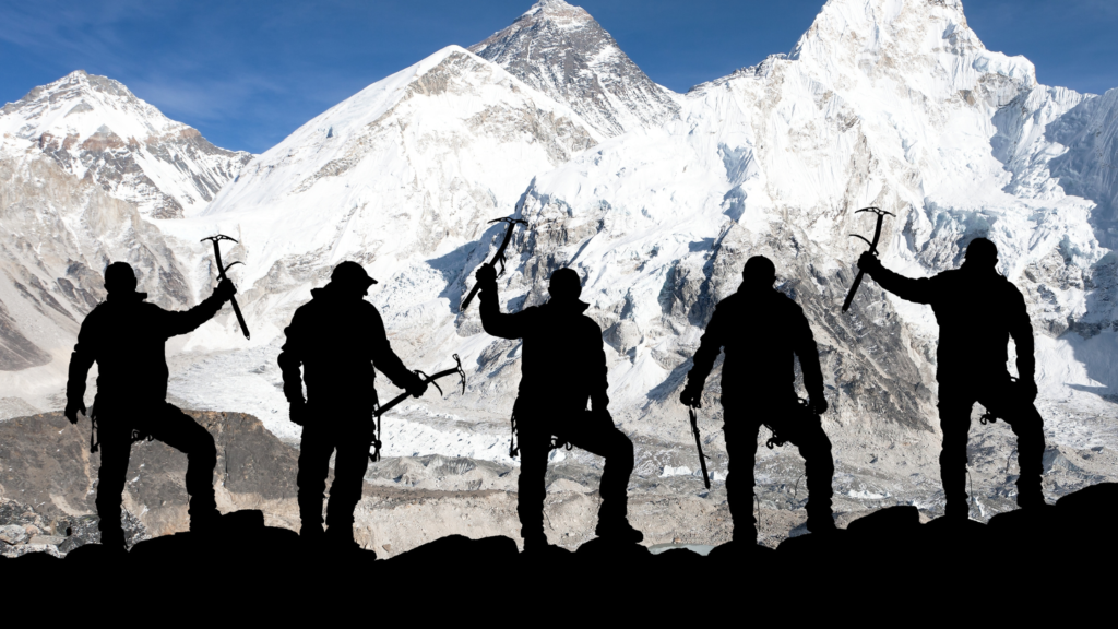 Five climbers silhouetted against a snow-covered mountain range, each holding an ice axe.